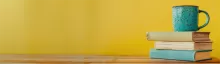 stack of books on yellow background